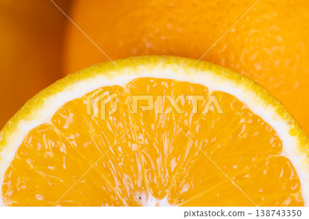 Vivid citrus piece radiating freshness. Brightly lit orange slice full of juice and vitality. Detailed view of ripe orange wedge bursting with juice and radiant sunlight 138743350