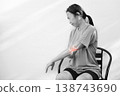 Monochrome photo of woman suffering from severe elbow pain, holding her arm with a red glowing anatomical bone graphic overlay showing joint inflammation, arthritis, or injury in medical concept. 138743690