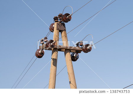 Detailed electrical equipment. Sophisticated array of electrical insulators composed of ceramics and metal parts showcasing industrial craftsmanship and technical intricacy 138743753