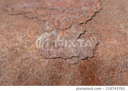 Close up rust on metal peeling flake revealing layered brittle crust and curled edges, rough surface offers tactile depth for restoration and material concept visuals Close up rust on metal peeling flake revealing layered brittle crust and curled edges, rough surface offers tactile depth for restoration and material concept visuals 138743762