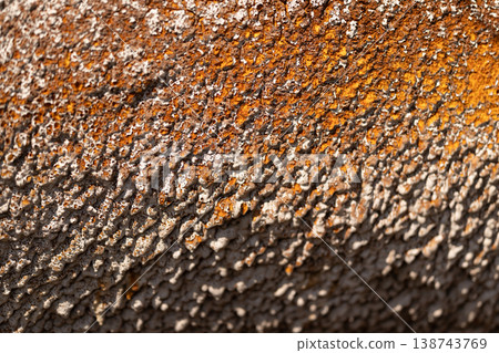 Rusty textured pattern. Weathered material showing decay and resilience. Granular surface displaying oxidation and weathered patterns highlighting decay and strength 138743769
