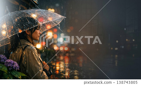 A rainy night in the city, a woman holding a plastic umbrella, and hydrangeas (copy space) 138743805