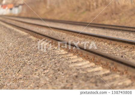 Relaxing pastoral trip with sunlight shining on old rails. Serene rural adventure as train tracks blend into picturesque landscape with sunshine illuminating weathered metal Relaxing pastoral trip with sunlight shining on old rails. Serene rural adventure as train tracks blend into picturesque landscape with sunshine illuminating weathered metal 138743808