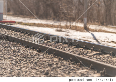 Train nearing countryside station scene. Calm midday approach to rustic train station scene. Serene midday scene of approaching rural railway platform with tracks and gravel Train nearing countryside station scene. Calm midday approach to rustic train station scene. Serene midday scene of approaching rural railway platform with tracks and gravel 138743814