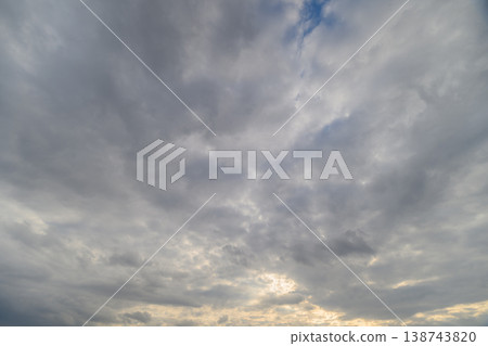 Calm dawn sky setting. Peaceful sunrise clouds creating soothing atmosphere for relaxation. Soft morning cloud cover gracing sky with gentle light and tranquil ambiance Calm dawn sky setting. Peaceful sunrise clouds creating soothing atmosphere for relaxation. Soft morning cloud cover gracing sky with gentle light and tranquil ambiance 138743820