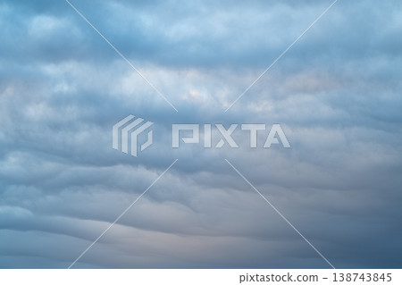 Stratocumulus layers create cool expressive formations. Horizontal bands of stratocumulus clouds evoke cinematic landscape emphasizing atmospheric storytelling and mood Stratocumulus layers create cool expressive formations. Horizontal bands of stratocumulus clouds evoke cinematic landscape emphasizing atmospheric storytelling and mood 138743845