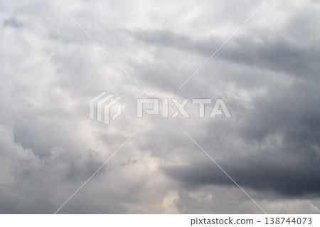 Somber overcast atmosphere. Dark clouds obscure faint light. Gloomy sky veiled by thick cloud cover. Ominous overcast sky concealed beneath dense layers of clouds Somber overcast atmosphere. Dark clouds obscure faint light. Gloomy sky veiled by thick cloud cover. Ominous overcast sky concealed beneath dense layers of clouds 138744073