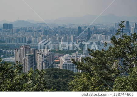 Panoramic view of Seoul city skyline with high-rise buildings and mountains from Daemosan mountain peak. Panoramic view of Seoul city skyline with high-rise buildings and mountains from Daemosan mountain peak. 138744605