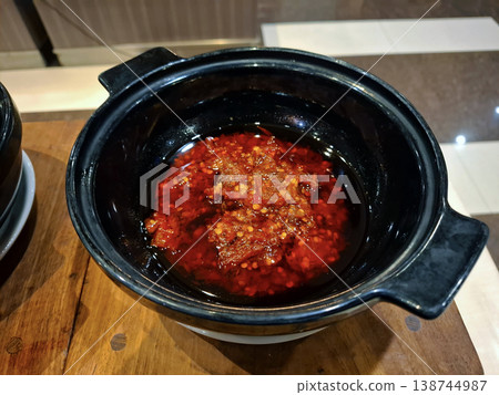 Red Chili Sauce in Black Bowl on Wooden Table Red Chili Sauce in Black Bowl on Wooden Table 138744987