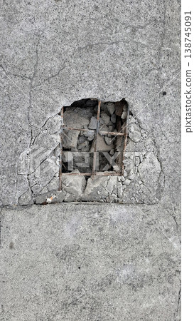 Cinematic Melancholic concrete wall with broken metal grate and exposed rocks Cinematic Melancholic concrete wall with broken metal grate and exposed rocks 138745091