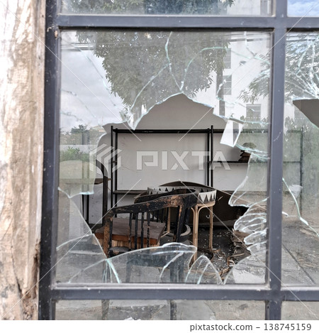 Gritty Cinematic scene of broken glass and damaged furniture outdoors 138745159