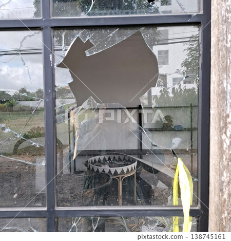 Gritty Cinematic scene of broken glass window with debris inside Gritty Cinematic scene of broken glass window with debris inside 138745161