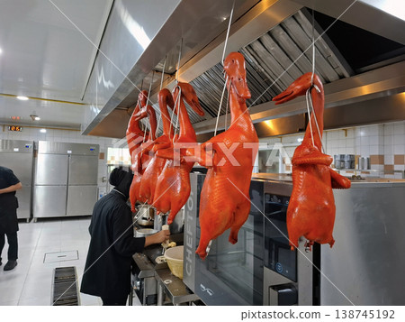 Roasted Peking Ducks Hanging in a Busy Kitchen Roasted Peking Ducks Hanging in a Busy Kitchen 138745192