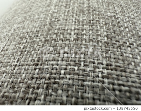 Textured fabric closeup showing woven pattern and fibers, suitable for backgrounds and materials 138745550