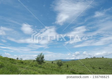 Vast grassy hills and a dynamic summer blue sky. 138746625