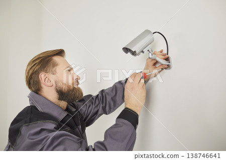 Focused Technician Installing Cctv At Home Or Office Focused Technician Installing Cctv At Home Or Office 138746641