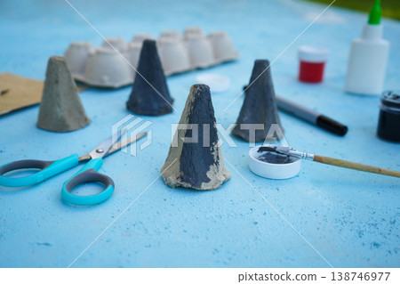 A simple DIY childrens craft is a family of mice made from cardboard egg packaging. Step 2 color it in gray, close up. A simple DIY childrens craft is a family of mice made from cardboard egg packaging. Step 2 color it in gray, close up. 138746977