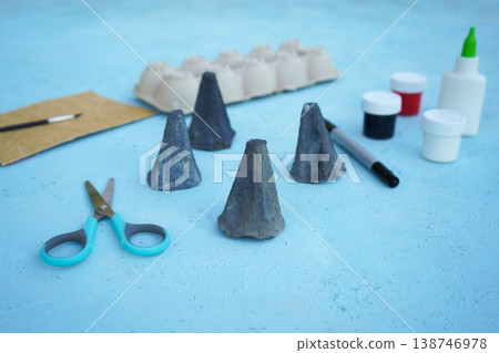 A simple DIY childrens craft is a family of mice made from cardboard egg packaging. Color it in gray, close up. A simple DIY childrens craft is a family of mice made from cardboard egg packaging. Color it in gray, close up. 138746978