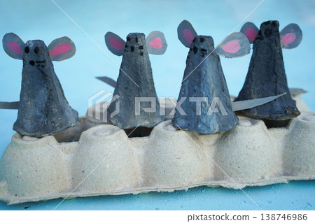A family of mice, hand-made from a cardboard egg box, close-up. An eco-friendly idea for reuse, decorations for Easter, a gift for dad, mom, on family day. A family of mice, hand-made from a cardboard egg box, close-up. An eco-friendly idea for reuse, decorations for Easter, a gift for dad, mom, on family day. 138746986