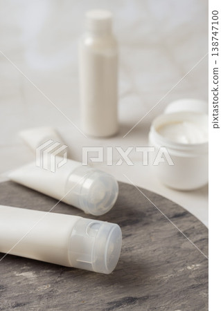 Minimal skincare products with cosmetic cream jar and tubes on marble surface, beauty routine and skincare treatment concept Minimal skincare products with cosmetic cream jar and tubes on marble surface, beauty routine and skincare treatment concept 138747100