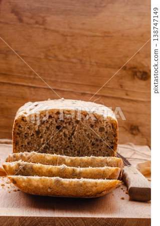 Sliced whole wheat bread on cutting board Sliced whole wheat bread on cutting board 138747149