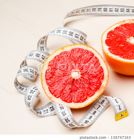 Dieting. Grapefruit with measuring tape Dieting. Grapefruit with measuring tape 138747163