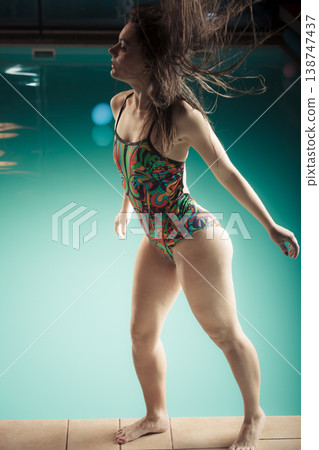 Woman in swimsuit stand at edge swimming pool. Woman in swimsuit stand at edge swimming pool. 138747437