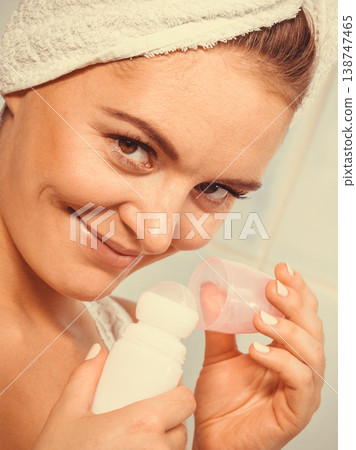 Woman holds stick deodorant cosmetic in hands Woman holds stick deodorant cosmetic in hands 138747465