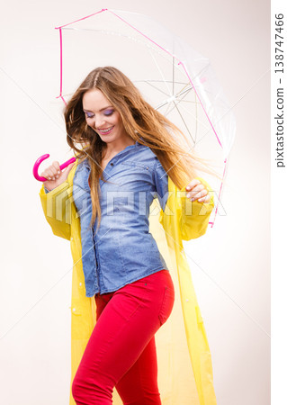 Woman wearing waterproof coat under umbrella Woman wearing waterproof coat under umbrella 138747466