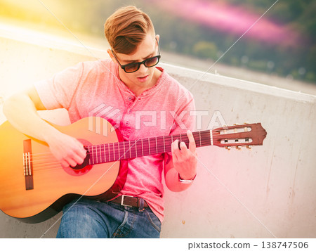 Trendy guy with guitar outdoor Trendy guy with guitar outdoor 138747506