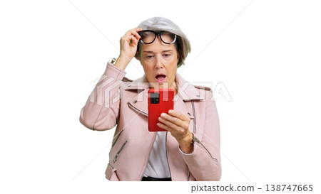 Senior woman reacting with surprise and shock to smartphone news Senior woman reacting with surprise and shock to smartphone news 138747665
