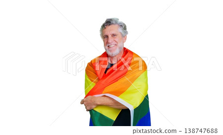 Senior man smiling, embracing rainbow pride flag 138747688