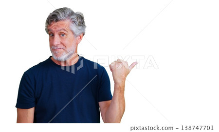 Senior man pointing thumb to side for advertising Senior man pointing thumb to side for advertising 138747701