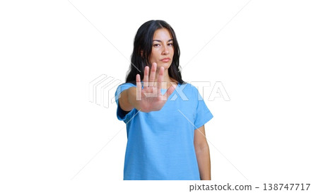 Woman making stop gesture expressing denial and boundaries 138747717