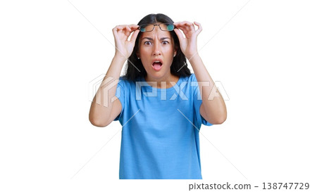 Woman feeling surprise and disbelief lifting glasses 138747729