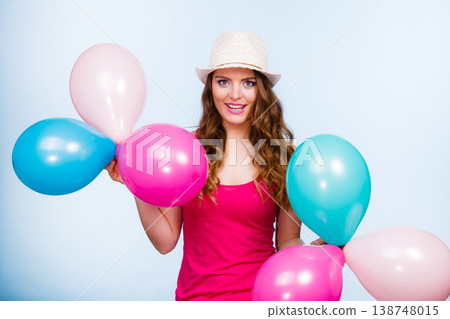 Woman playing with many colorful balloons Woman playing with many colorful balloons 138748015
