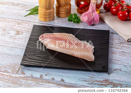 Raw tilapia fish fillet over board Raw tilapia fish fillet over board 138748366