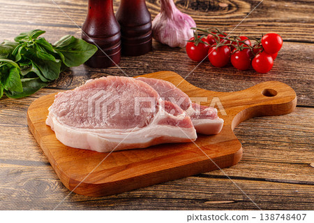 Raw pork steak over board Raw pork steak over board 138748407