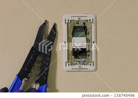 The recessed switch with the cover removed and the VVF wire stripper. 138748496