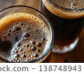 Dark craft beer in glasses with rich foam and bubbles closeup 138748943