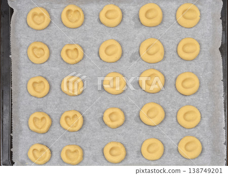Raw Thumbprint Heart Cookies on Baking Sheet Raw Thumbprint Heart Cookies on Baking Sheet 138749201