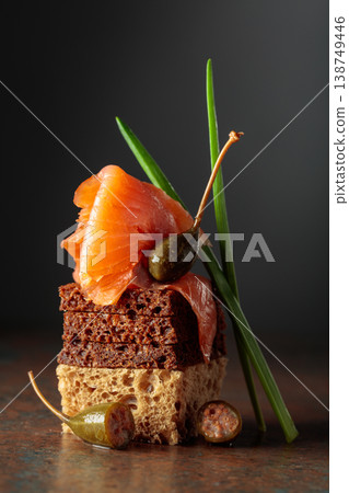 Open sandwich with salted salmon and capers, garnished with green onion. Open sandwich with salted salmon and capers, garnished with green onion. 138749446