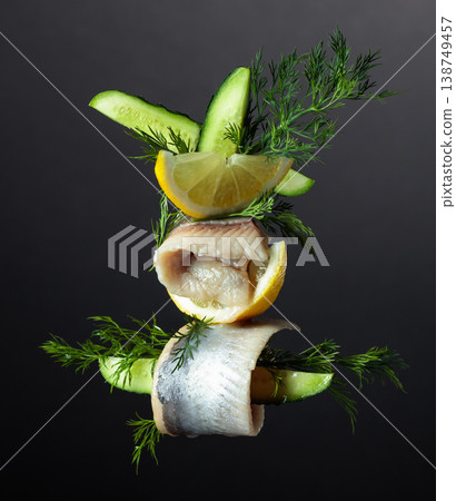 Herring fillet in oil with lemon, cucumber, and dill. 138749457