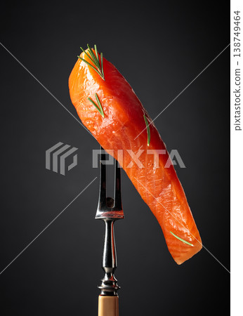 Smocked salmon fillet on a black background. Smocked salmon fillet on a black background. 138749464