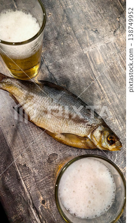 Fishing scene with fish on wood, beer glasses nearby Fishing scene with fish on wood, beer glasses nearby 138749952
