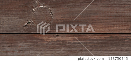 Scratched dark wood surface with horizontal groove showing natural texture and wear 138750543