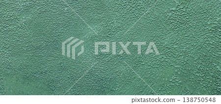 Textured turquoise painted wall surface with cracked weathered paint and rough pattern 138750548