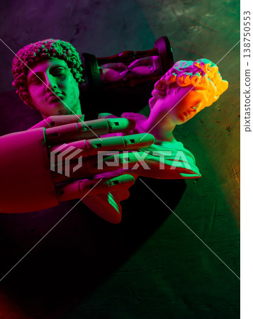 Robotic hand touching classical sculpture in neon lighting for artificial intelligence concept 138750553