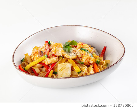 Stir-fried rice noodles with shrimp, squid, and mixed vegetables in a ceramic bowl isolated on white. 138750803