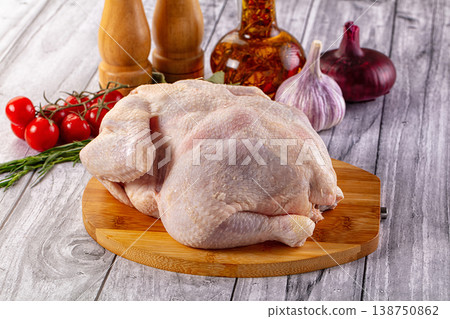 Raw whole chicken over board 138750862